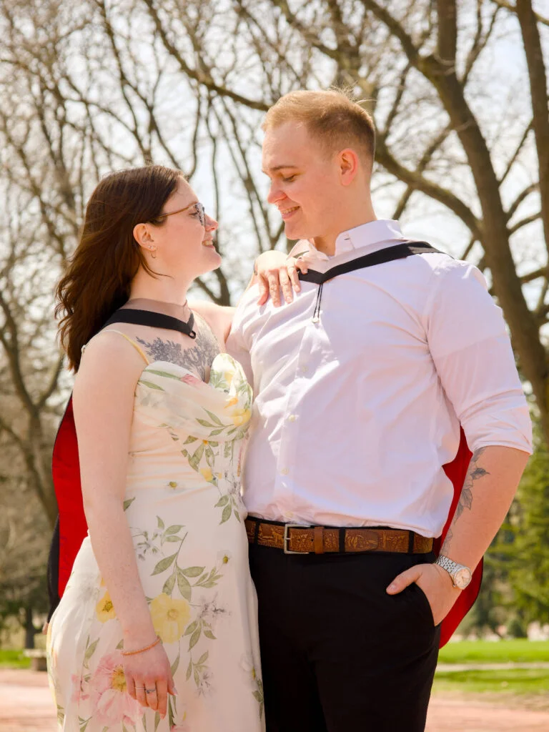 Two graduates photographed together on campus