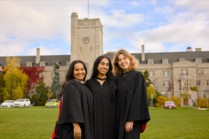 A professional photo of three Guelph grads on the University of Guelph campus. on Johnston Green, The photo is from Guelph Grad Photos. The background is the University of Guelph Campus.