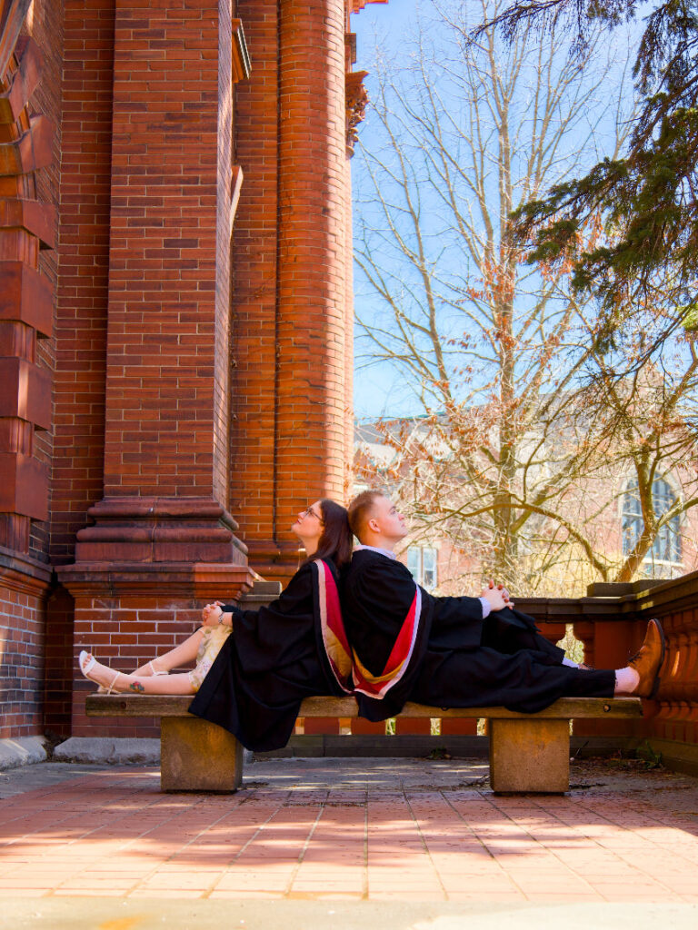Graduates framed by historic architecture on the north side of campus