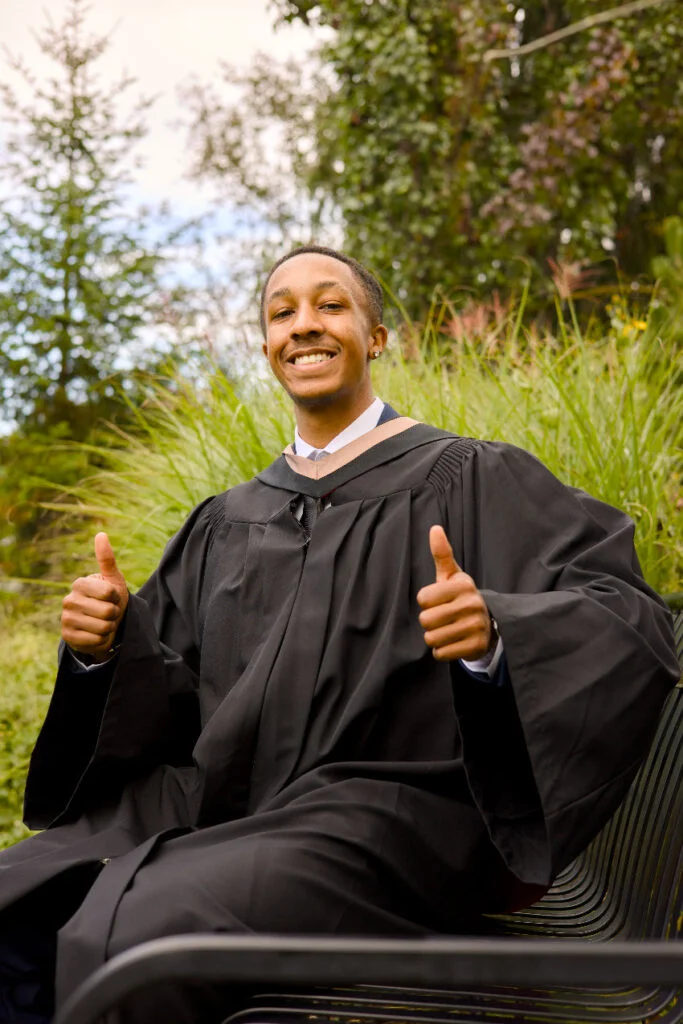 A graduate photographed in The Arboretum gardens at the University of Guelph