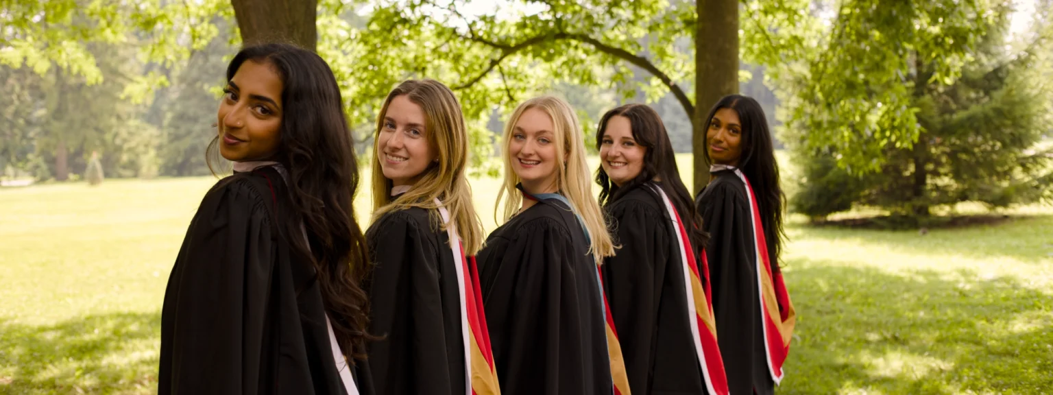 Graduating friends in gowns, ready for their group session